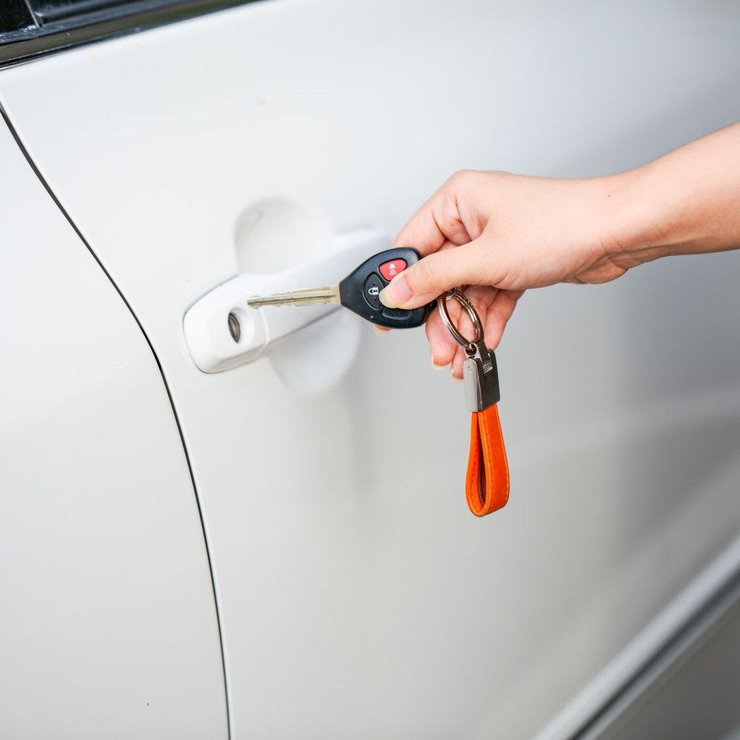 Laser Cut Car Keys Explained, and Why the Name Is Wrong laser cut car keys explained, a car key blade turned in the door lock of a modern car