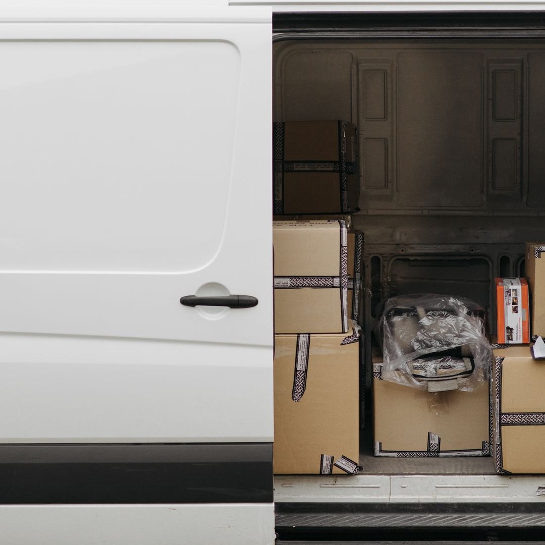 locked out of the van with the tools inside, the open side door of a loaded white work van